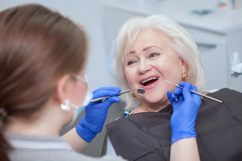 Elderly woman smiling during dental checkup – Restorative Dentistry at SpringLake Dental Woodland, CA